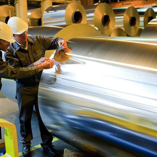 Workers inspecting aluminium foil quality