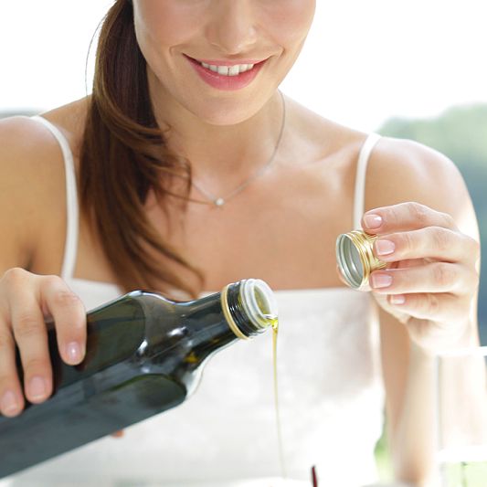 Woman with cooking oil bottle and screw cab