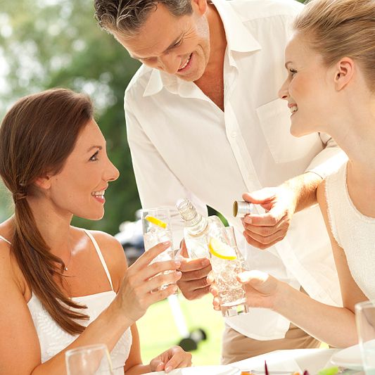 People drinking water in the garden
