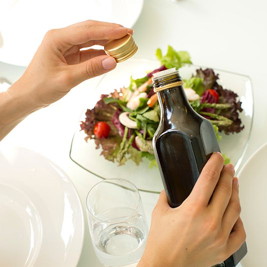 cooking oil with screw cap above salad